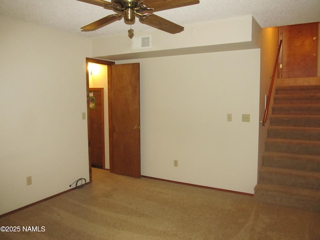 2422 N Whispering Pines Way, Flagstaff, AZ 86004 - spare room featuring carpet flooring, stairway, a ceiling fan, and a textured ceiling