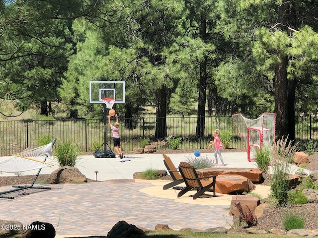 view of basketball court featuring fence