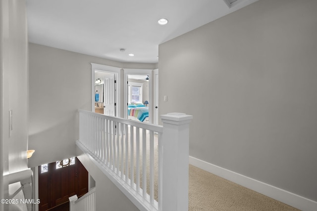 hallway featuring carpet, recessed lighting, an upstairs landing, and baseboards