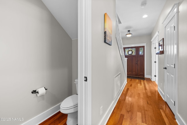 doorway featuring visible vents, recessed lighting, baseboards, and light wood-type flooring