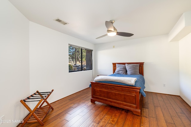 bedroom with dark wood-type flooring and ceiling fan