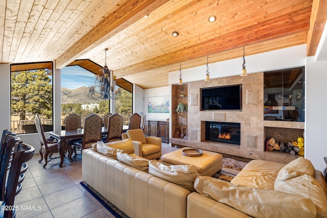 tiled living room featuring a tile fireplace, vaulted ceiling with beams, a notable chandelier, and wood ceiling