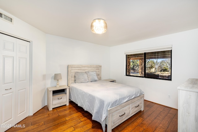 bedroom featuring dark hardwood / wood-style floors and a closet