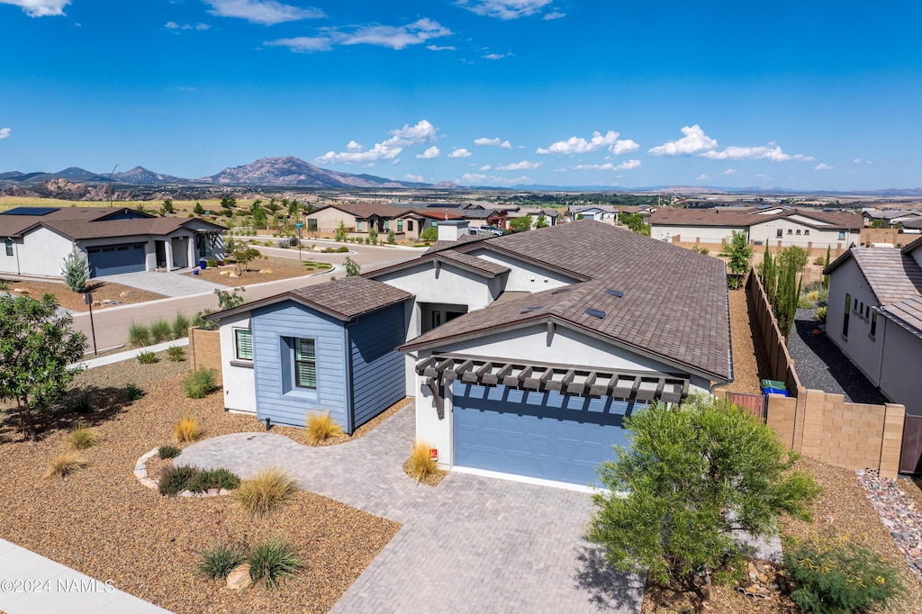 view of front of property featuring a garage and a mountain view