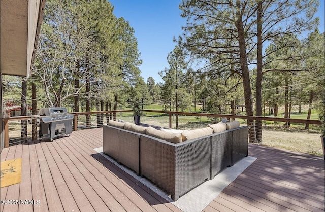 wooden terrace with outdoor lounge area and area for grilling