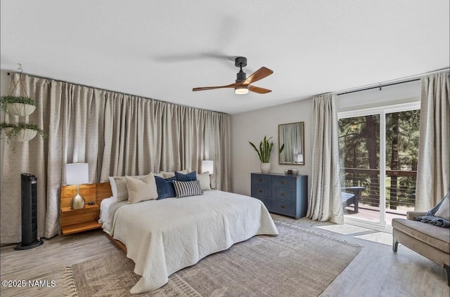 bedroom featuring a ceiling fan, access to outside, and wood finished floors