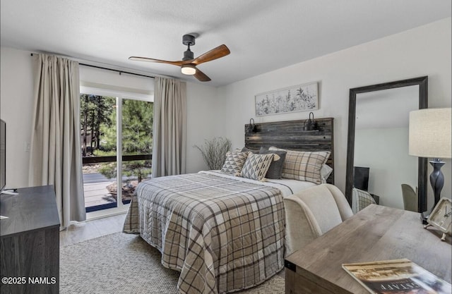 bedroom with a textured ceiling, wood finished floors, a ceiling fan, and access to outside