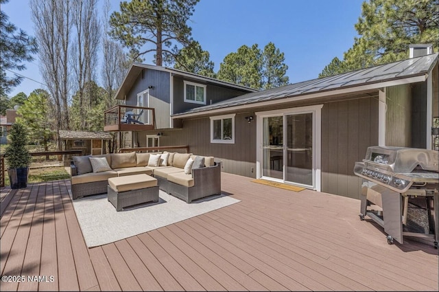 wooden deck featuring a grill and an outdoor hangout area