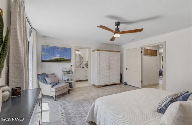 bedroom featuring light wood-style flooring, a ceiling fan, and ensuite bathroom