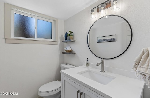 half bathroom with toilet and vanity