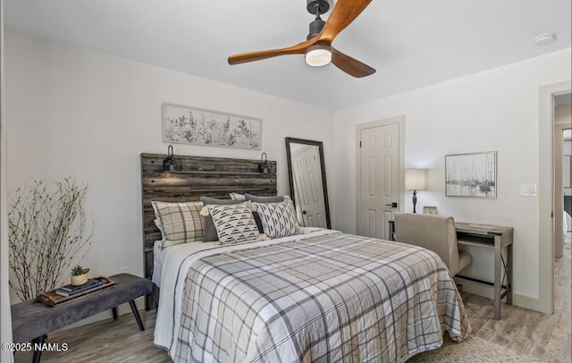 bedroom featuring baseboards, ceiling fan, and wood finished floors