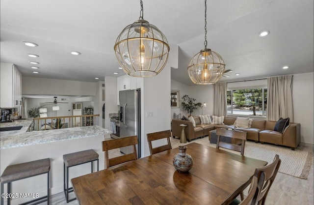 dining room with recessed lighting, ceiling fan with notable chandelier, and baseboards