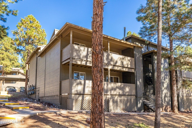 view of side of home featuring a balcony