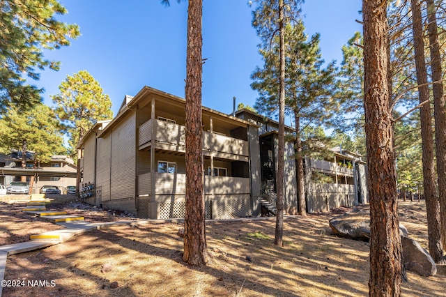 rear view of property featuring a balcony