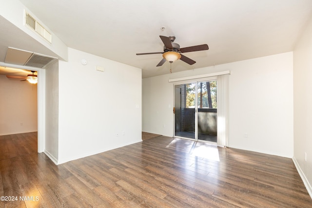 spare room with ceiling fan and dark hardwood / wood-style flooring