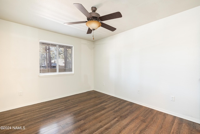 unfurnished room with ceiling fan and dark wood-type flooring