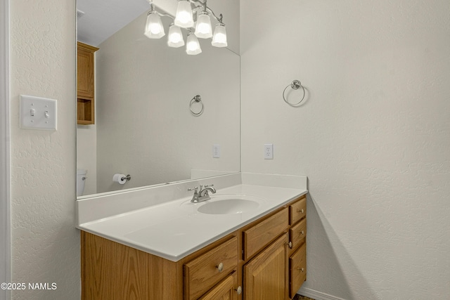 bathroom with vanity and a textured wall