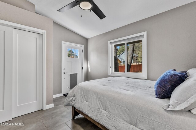 bedroom with ceiling fan and vaulted ceiling