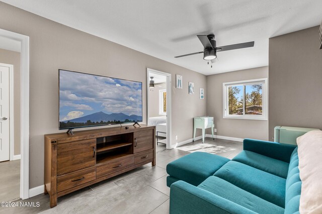 tiled living room featuring ceiling fan