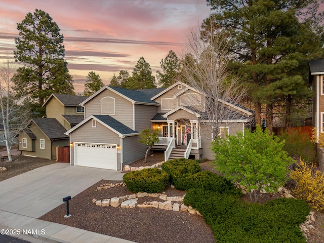 2396 N Colter Dr, Flagstaff, AZ 86004 - view of front of house with roof with shingles, covered porch, and concrete driveway