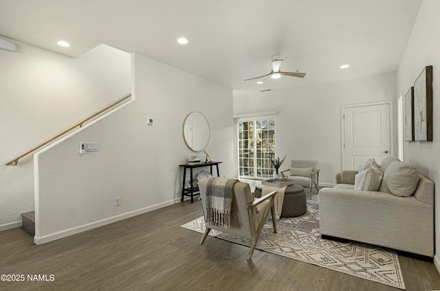 living room with ceiling fan and dark hardwood / wood-style floors