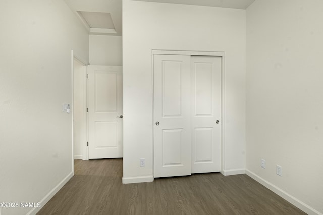 unfurnished bedroom featuring a closet and dark hardwood / wood-style floors