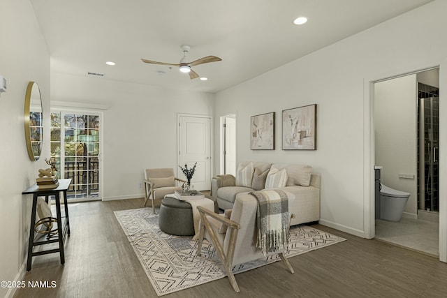 living room with dark hardwood / wood-style floors and ceiling fan