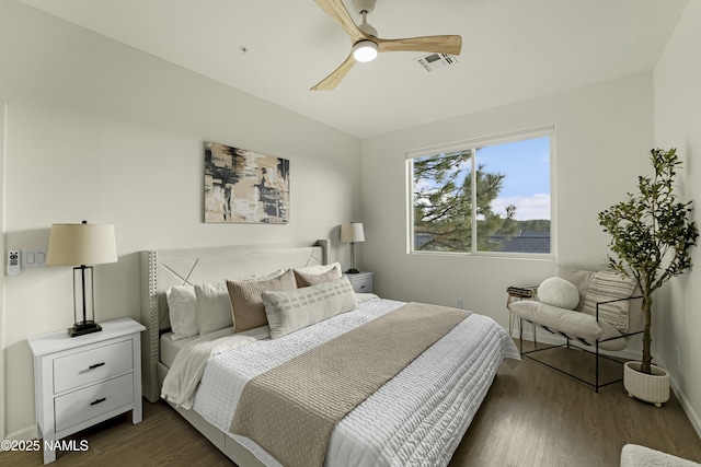 bedroom with dark hardwood / wood-style floors and ceiling fan