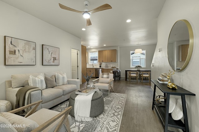 living room with ceiling fan, dark wood-type flooring, and sink