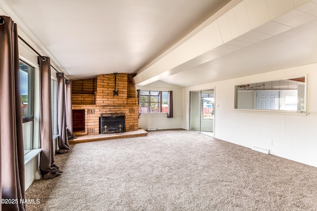 unfurnished living room featuring visible vents, vaulted ceiling, carpet flooring, and a brick fireplace