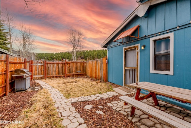 yard at dusk with a fenced backyard