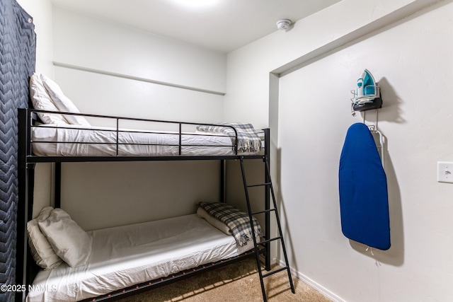 carpeted bedroom featuring baseboards
