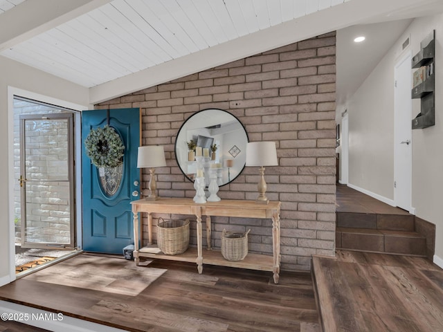 entrance foyer with lofted ceiling with beams, wood finished floors, and baseboards