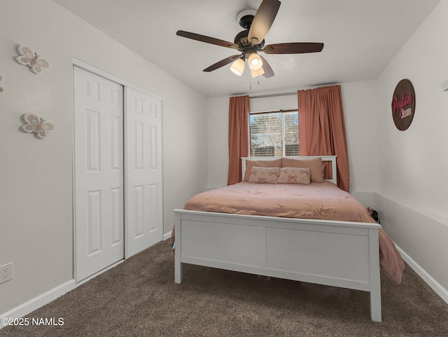 bedroom featuring a ceiling fan, baseboards, dark colored carpet, and a closet