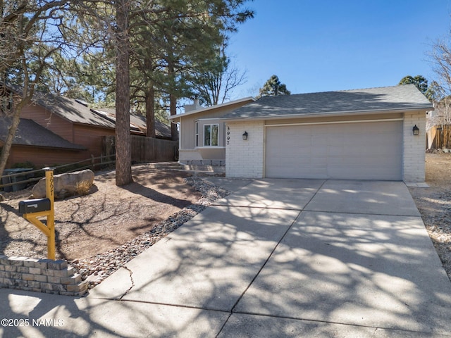 single story home featuring brick siding, a shingled roof, fence, a garage, and driveway