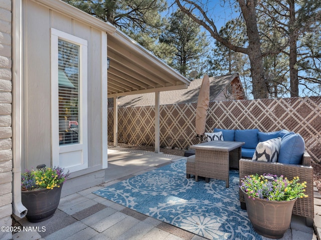 view of patio with outdoor lounge area and fence