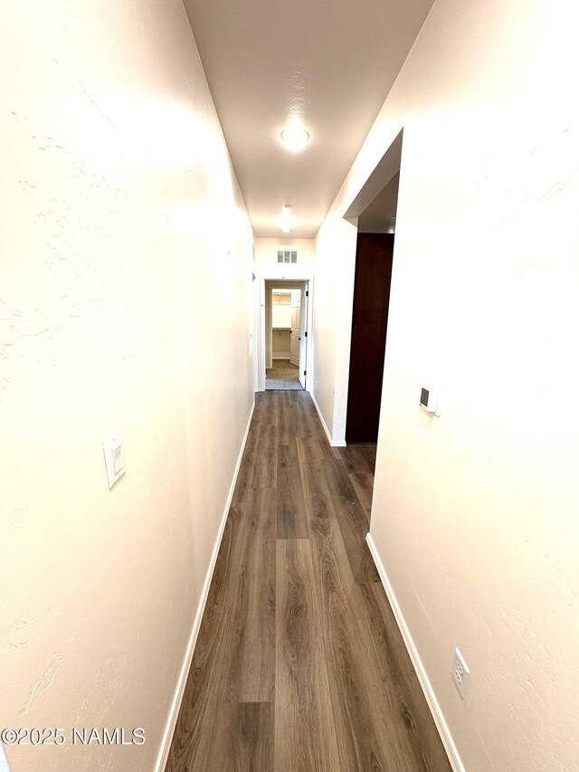 1650 E Ponderosa Pkwy Unit 7-231, Flagstaff, AZ 86001 - hall with baseboards, visible vents, and dark wood-style floors