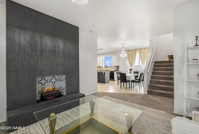 tiled living room featuring a large fireplace