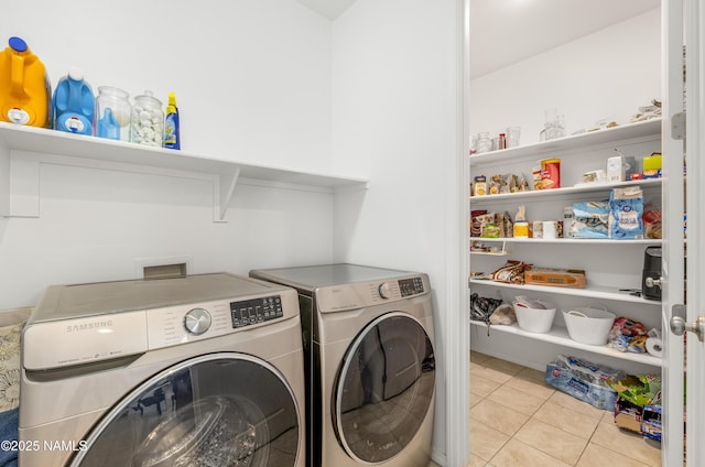 laundry area with light tile patterned flooring and separate washer and dryer