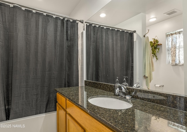 bathroom with vanity and shower / tub combo with curtain