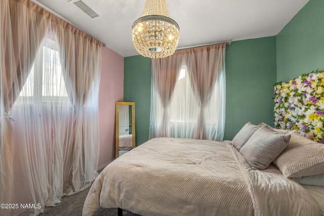 11941 Pegasus Rd, Bellemont, AZ 86015 - carpeted bedroom with a chandelier and multiple windows