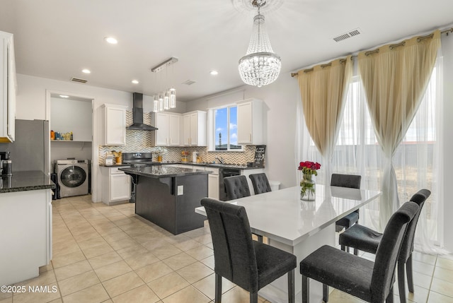 tiled dining space featuring washer / clothes dryer