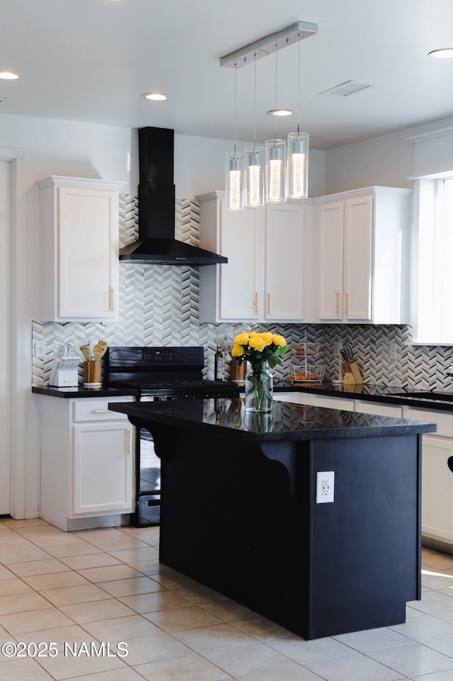 11941 Pegasus Rd, Bellemont, AZ 86015 - kitchen featuring wall chimney range hood, tasteful backsplash, a kitchen island, white cabinets, and recessed lighting