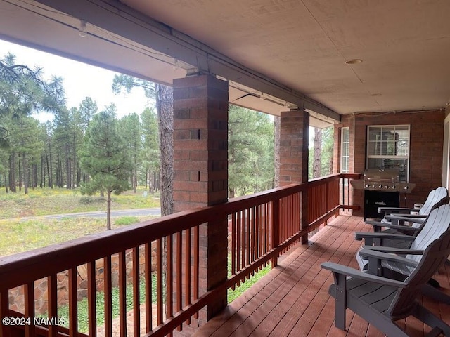 wooden deck with a grill