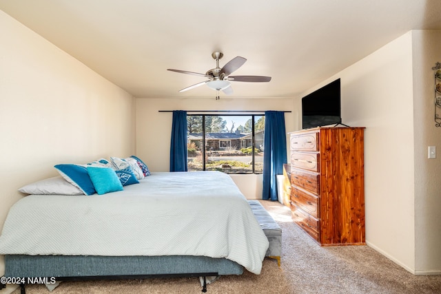 bedroom with ceiling fan, carpet, and baseboards