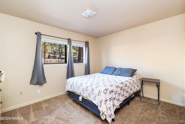 bedroom featuring carpet and baseboards