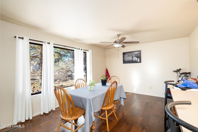 dining room with ceiling fan, dark wood-style flooring, and baseboards