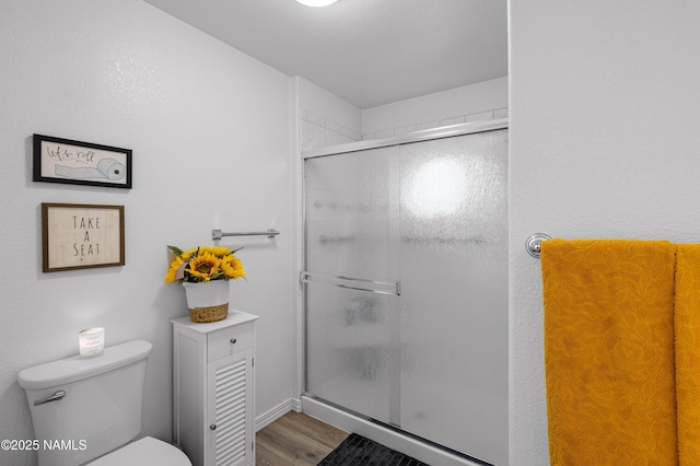 706 N Hulet Ln, Flagstaff, AZ 86004 - bathroom with toilet, a shower stall, and wood finished floors