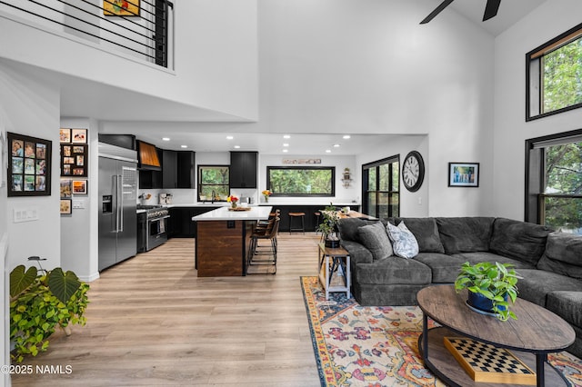 706 N Hulet Ln, Flagstaff, AZ 86004 - living room with high vaulted ceiling, light wood-type flooring, a ceiling fan, baseboards, and recessed lighting