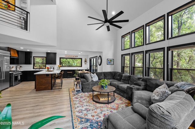 706 N Hulet Ln, Flagstaff, AZ 86004 - living room with high vaulted ceiling, light wood finished floors, ceiling fan, and recessed lighting